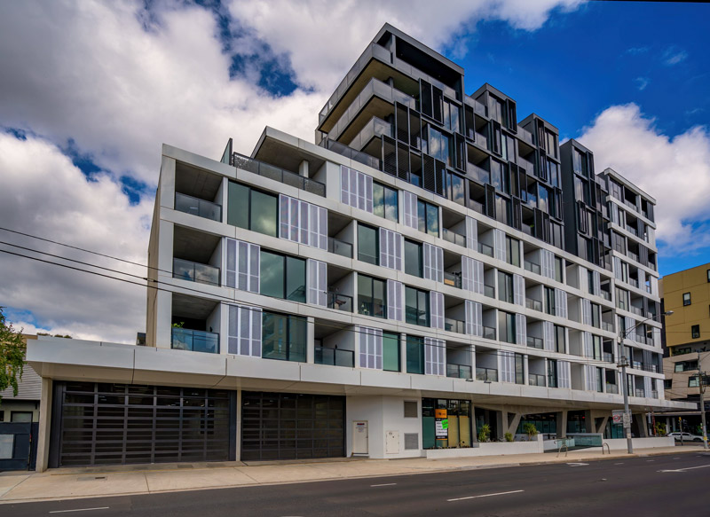 Commercial garage doors at street level of a multi-storey building
