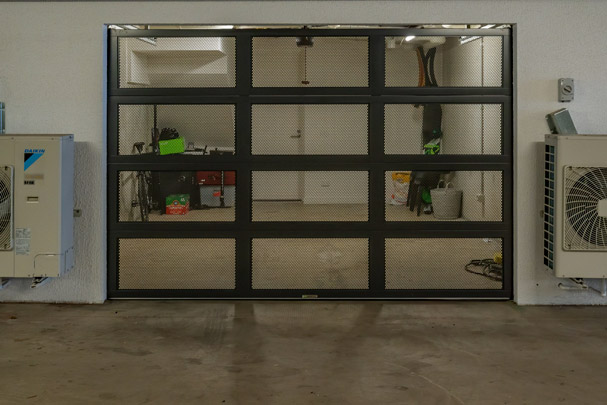 Mesh-panel garage door in a commercial service area