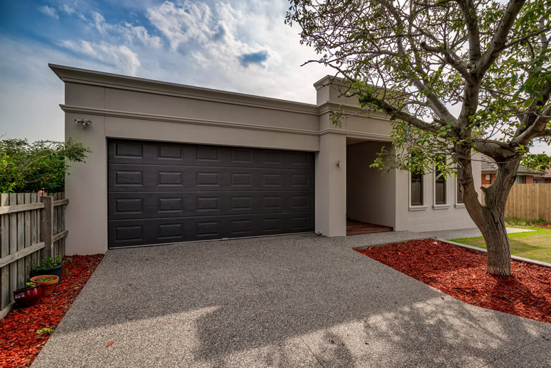 Modern home with a dark panelled garage door