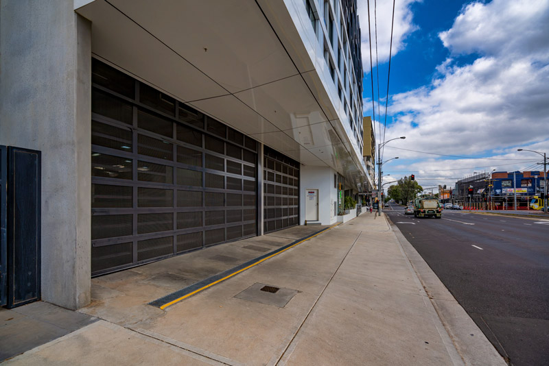 Commercial garage doors along a city building frontage