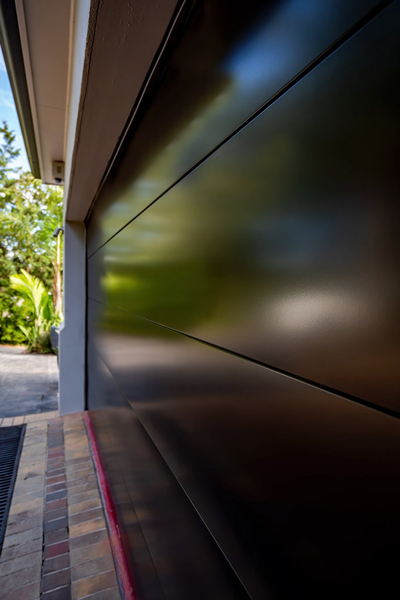 Close-up of a dark garage door with horizontal panel lines
