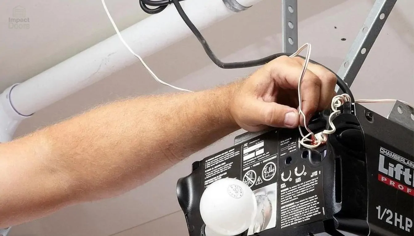 Hand adjusting the controls on a garage door opener