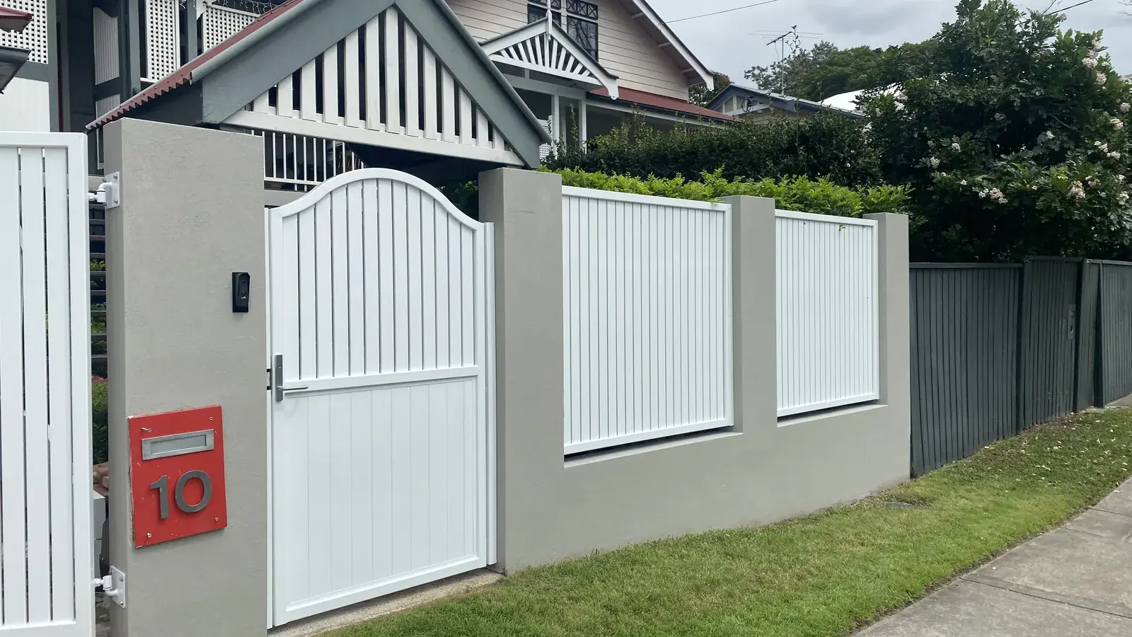Pedestrian gate set beside matching boundary fencing